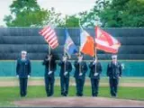 Color guard presenting flags on the field