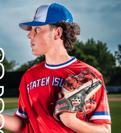 Young pitcher in a Staten Island jersey tossing a baseball